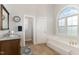 Bright bathroom with soaking tub, granite vanity, tiled floor, and separate toilet room at 5136 Liberty Grove Rd, Liberty, NC 27298