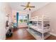 A bedroom with hardwood floors, pink wallpaper and a set of bunk beds at 5136 Liberty Grove Rd, Liberty, NC 27298