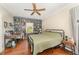 Bedroom with hardwood floors, ceiling fan, built-in bookshelves, and view to the outside at 5136 Liberty Grove Rd, Liberty, NC 27298