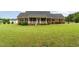 Classic brick home featuring a covered front porch, black shutters and a large front yard at 5136 Liberty Grove Rd, Liberty, NC 27298