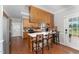 Traditional kitchen with wood cabinets, breakfast bar, stainless fridge, and adjacent eat-in area at 5136 Liberty Grove Rd, Liberty, NC 27298