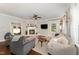 Cozy living room with a fireplace, hardwood floors and stylish neutral furniture at 5136 Liberty Grove Rd, Liberty, NC 27298