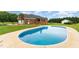 Aerial view of an in-ground pool behind a brick home at 5136 Liberty Grove Rd, Liberty, NC 27298