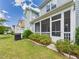 Charming backyard featuring a well-manicured lawn, mature shrubbery, and a cozy screened-in porch, perfect for outdoor living at 524 Rowanwood Way, Apex, NC 27523