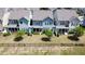 Aerial view of several homes' backyards, featuring lawns, fences, and patio areas at 524 Rowanwood Way, Apex, NC 27523