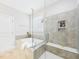 A large soaking tub and tiled shower in a bright bathroom at 524 Rowanwood Way, Apex, NC 27523