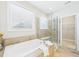 Bright bathroom features a soaking tub and glass enclosed shower at 524 Rowanwood Way, Apex, NC 27523