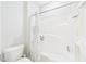 Bright white bathroom featuring a bathtub with shower and a white toilet at 524 Rowanwood Way, Apex, NC 27523