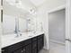 Bathroom with double sink vanity, granite countertop, and large mirror at 524 Rowanwood Way, Apex, NC 27523