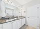 Bright bathroom features double sinks, granite countertops, and white cabinetry at 524 Rowanwood Way, Apex, NC 27523