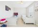 Bright bedroom featuring two twin beds, a ceiling fan, and neutral decor at 524 Rowanwood Way, Apex, NC 27523
