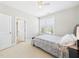 Bedroom with a ceiling fan, large window and direct entry to bathroom at 524 Rowanwood Way, Apex, NC 27523