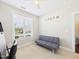 Bright bedroom featuring a large window, futon, and 'DREAM' wall decor at 524 Rowanwood Way, Apex, NC 27523