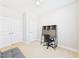Comfortable bedroom with neutral carpeting, a desk, a futon, and two closets at 524 Rowanwood Way, Apex, NC 27523