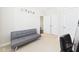 Well-lit bedroom with a futon, carpeted floor, and closet, creating a welcoming space at 524 Rowanwood Way, Apex, NC 27523