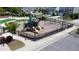 Wide aerial view of the neighborhood pool and playground, complete with lounge chairs and amenities at 524 Rowanwood Way, Apex, NC 27523