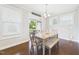 Dining area with natural light, stylish furniture, and backyard access at 524 Rowanwood Way, Apex, NC 27523