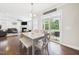 Dining area with natural light and backyard access connected to a comfortable living room with a fireplace at 524 Rowanwood Way, Apex, NC 27523