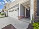 The front of the house showcasing the gray and stone facade, garage, and well maintained landscaping at 524 Rowanwood Way, Apex, NC 27523