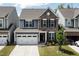 Charming two-story home with stone and siding, two-car garage and manicured front yard at 524 Rowanwood Way, Apex, NC 27523