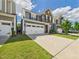 Charming two-story home featuring a stone and siding facade with a two-car garage and well-manicured lawn at 524 Rowanwood Way, Apex, NC 27523