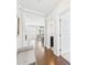 Hallway with hardwood floors leading to dining area and bathroom at 524 Rowanwood Way, Apex, NC 27523