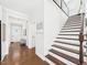 Hallway features hardwood floors, stairs, and a glimpse of the front door at 524 Rowanwood Way, Apex, NC 27523
