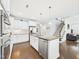 Bright open kitchen with stainless steel appliances, white cabinets, granite counters, and a large center island at 524 Rowanwood Way, Apex, NC 27523