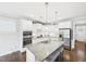 Open kitchen features a large island with seating, stainless appliances and plenty of cabinet space at 524 Rowanwood Way, Apex, NC 27523