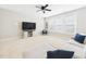 Spacious living room with ceiling fan, recessed lighting, and large windows at 524 Rowanwood Way, Apex, NC 27523