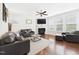 Spacious living room featuring hardwood floors, a fireplace, and modern furniture at 524 Rowanwood Way, Apex, NC 27523