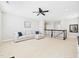 Spacious living area featuring neutral tones, plush seating, and a ceiling fan, creating a relaxing atmosphere at 524 Rowanwood Way, Apex, NC 27523