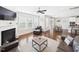 Bright living room with fireplace, hardwood floors, and a view of the dining area and kitchen at 524 Rowanwood Way, Apex, NC 27523