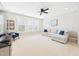 Living room with bright lights and ceiling fan at 524 Rowanwood Way, Apex, NC 27523