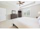Bright and airy main bedroom with carpet flooring, dresser, and ceiling fan at 524 Rowanwood Way, Apex, NC 27523