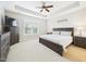 Relaxing main bedroom features a ceiling fan, a window, and an ensuite bathroom at 524 Rowanwood Way, Apex, NC 27523