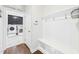Practical mudroom featuring laundry area, storage bench, and access to pantry at 524 Rowanwood Way, Apex, NC 27523