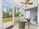 Screened-in porch provides serene views of a well-maintained lawn and lush landscaping, creating a peaceful retreat at 524 Rowanwood Way, Apex, NC 27523
