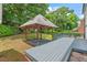 The backyard features a wooden gazebo, a deck, and green landscaping, making it perfect for outdoor gatherings at 5409 Knollwood Rd Rd, Raleigh, NC 27609