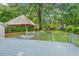 Backyard featuring a gazebo, lush landscaping, mature trees, and a playset at 5409 Knollwood Rd Rd, Raleigh, NC 27609