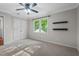 Bright bedroom with soft carpet, double closets, and windows with outside views at 5409 Knollwood Rd Rd, Raleigh, NC 27609