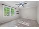 Inviting bedroom with neutral carpet, a ceiling fan, and large windows offering plenty of natural light at 5409 Knollwood Rd Rd, Raleigh, NC 27609
