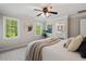 Bedroom with neutral walls and carpet, a ceiling fan, and an attached bathroom at 5409 Knollwood Rd Rd, Raleigh, NC 27609