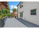 Spacious deck for outdoor relaxation featuring white siding, French doors, and gray painted wood at 5409 Knollwood Rd Rd, Raleigh, NC 27609