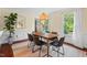 Dining room with modern lighting, sleek black chairs, and a large area rug at 5409 Knollwood Rd Rd, Raleigh, NC 27609