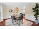 Dining room featuring a modern light fixture, seating for six, and an adjacent living space at 5409 Knollwood Rd Rd, Raleigh, NC 27609