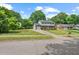 Well-maintained two-story home with lush front lawn, charming curb appeal, and a paved driveway at 5409 Knollwood Rd Rd, Raleigh, NC 27609