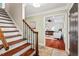 Welcoming foyer boasts wood and tile floors, a staircase, and an entrance into the living room at 5409 Knollwood Rd Rd, Raleigh, NC 27609