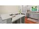 A kitchen featuring gray cabinets, stainless steel appliances, and a breakfast bar at 5409 Knollwood Rd Rd, Raleigh, NC 27609