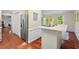 Bright kitchen with a stainless steel refrigerator and wood floors at 5409 Knollwood Rd Rd, Raleigh, NC 27609